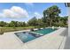 A modern backyard pool design with stepping stones and plenty of patio space at 5074 Isleworth Country Club Dr, Windermere, FL 34786