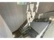 Elegant staircase with glass railings and stylish chandelier, creating a modern and sophisticated look at 5074 Isleworth Country Club Dr, Windermere, FL 34786