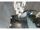 Modern staircase with glass railings, wood steps and unique decorative lighting fixture at 5074 Isleworth Country Club Dr, Windermere, FL 34786