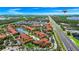 Aerial view of a resort featuring pools, a lake, and lush landscaping, near the highway at 5566 Metrowest Blvd # 10, Orlando, FL 32811