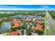 Overhead view of a community with a lake and a highway, showing multiple residential buildings at 5566 Metrowest Blvd # 10, Orlando, FL 32811