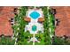 Overhead view of a luxurious resort-style pool area surrounded by lush landscaping and elegant architecture at 5566 Metrowest Blvd # 10, Orlando, FL 32811