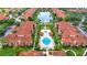 Aerial view of condo community showcasing the pools, landscaping, and lake at 5566 Metrowest Blvd # 10, Orlando, FL 32811