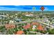 Aerial view of the condo community with a lush landscape, lake, and close proximity to Walmart at 5566 Metrowest Blvd # 10, Orlando, FL 32811