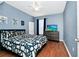 Stylish bedroom with a contrasting color scheme, wood floors, and a modern dresser with a TV at 5566 Metrowest Blvd # 10, Orlando, FL 32811