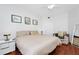 Bright bedroom featuring a comfortable bed, wood floors, and modern decor at 5566 Metrowest Blvd # 10, Orlando, FL 32811