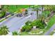 Community entrance gate with palm trees and a guardhouse, providing a secure environment at 5566 Metrowest Blvd # 10, Orlando, FL 32811