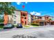 Exterior view showcasing a multi-story building with covered parking and well-maintained landscaping at 5566 Metrowest Blvd # 10, Orlando, FL 32811