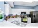 This kitchen features white cabinets, stainless appliances, and light countertops at 5566 Metrowest Blvd # 10, Orlando, FL 32811