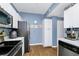 Well-lit kitchen with white cabinets, stainless steel appliances, and wood-look flooring at 5566 Metrowest Blvd # 10, Orlando, FL 32811