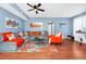 Bright living room with cozy sectional, orange accent chair, and modern decor at 5566 Metrowest Blvd # 10, Orlando, FL 32811