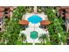 Overhead view of community pool area with two pools, gazebos, palm trees and lush landscaping at 5566 Metrowest Blvd # 10, Orlando, FL 32811