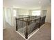 Hallway with decorative railing on the second floor of a home, featuring neutral walls and carpet at 5709 Gingham Dr, Kissimmee, FL 34758