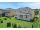 Expansive backyard featuring a covered patio and lush landscaping at 5819 Covington Cove Way, Orlando, FL 32829
