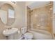 Bathroom featuring a pedestal sink, toilet and tiled tub with shower at 5819 Covington Cove Way, Orlando, FL 32829