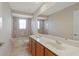Spacious bathroom featuring double sinks, tub and shower with tiling at 5819 Covington Cove Way, Orlando, FL 32829