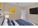 Bedroom with neutral wall color and large painting hanging on the wall at 5819 Covington Cove Way, Orlando, FL 32829