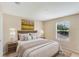 Bedroom featuring neutral wall color, rug, and large windows at 5819 Covington Cove Way, Orlando, FL 32829