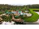 Stunning aerial view of community pool with pirate ship, water slide, and plentiful lounge seating at 5819 Covington Cove Way, Orlando, FL 32829