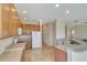 Well-lit kitchen with light wood cabinets, tiled floor, and modern appliances offer ample space for cooking at 5819 Covington Cove Way, Orlando, FL 32829