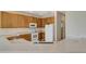 The kitchen features tile countertops, wooden cabinets and modern appliances offers a practical cooking space at 5819 Covington Cove Way, Orlando, FL 32829