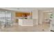 Open floor plan showcases the kitchen flowing into a casual dining area under natural light, and tiled floors at 5819 Covington Cove Way, Orlando, FL 32829