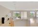 Open-concept living space with tiled floors, large windows, modern furniture under recessed lighting, and lots of space at 5819 Covington Cove Way, Orlando, FL 32829