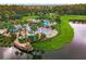 Aerial view of a large community pool area with palm trees, a pirate ship themed play area, and lounge chairs at 5819 Covington Cove Way, Orlando, FL 32829