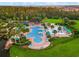 Overhead view of a stunning community pool area, including multiple pools, lounge chairs, and lush tropical landscaping at 5819 Covington Cove Way, Orlando, FL 32829