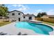Beautiful backyard featuring a refreshing pool and the back of the white home at 608 Pearl Rd, Winter Springs, FL 32708