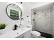 Sleek, updated bathroom with gray vanity, matte black fixtures and tiled shower with glass at 608 Pearl Rd, Winter Springs, FL 32708