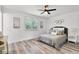 Spacious bedroom featuring wood flooring, white walls, and shuttered window at 608 Pearl Rd, Winter Springs, FL 32708