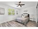 Bedroom with shuttered window and wood flooring and large bed with comfortable pillows at 608 Pearl Rd, Winter Springs, FL 32708