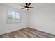 Bright bedroom featuring a ceiling fan, window with shutter blinds, and plank flooring at 608 Pearl Rd, Winter Springs, FL 32708