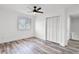 Bright bedroom with wood flooring, ceiling fan, and white shuttered windows at 608 Pearl Rd, Winter Springs, FL 32708