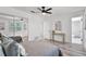 Bedroom featuring wood flooring and neutral decor, bathroom is seen through doorway at 608 Pearl Rd, Winter Springs, FL 32708