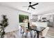 Dining area with sliding glass doors to the pool and a view of the modern kitchen at 608 Pearl Rd, Winter Springs, FL 32708