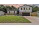 Charming two-story home with stone accents, a well-manicured lawn and attached two car garage at 608 Pearl Rd, Winter Springs, FL 32708