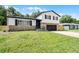 Charming two-story home featuring stone accents, black shutters, and a well-manicured lawn at 608 Pearl Rd, Winter Springs, FL 32708
