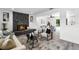 Open-concept living room with stone fireplace, modern furnishings, and dining area at 608 Pearl Rd, Winter Springs, FL 32708