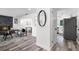 Bright living room flowing into the kitchen with a black framed mirror on the wall at 608 Pearl Rd, Winter Springs, FL 32708