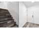 Staircase featuring modern wood treads, white risers, and a white handrail leading upstairs at 608 Pearl Rd, Winter Springs, FL 32708