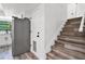 Staircase adjacent to kitchen featuring modern wood treads and white risers at 608 Pearl Rd, Winter Springs, FL 32708