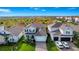 Beautiful two story home with well-manicured lawn and driveway, shown in an aerial view at 609 Big Pine Ave, Minneola, FL 34715