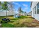 Large grassy backyard with white fence, playset, and mature trees at 609 Big Pine Ave, Minneola, FL 34715