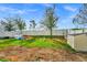 Large backyard featuring a playset, white privacy fence and storage shed at 609 Big Pine Ave, Minneola, FL 34715