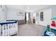 Cozy Bedroom with crib, changing table and accent decorations at 609 Big Pine Ave, Minneola, FL 34715