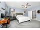 This primary bedroom features a ceiling fan, ensuite bathroom and an additional desk area at 609 Big Pine Ave, Minneola, FL 34715
