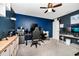 A bedroom with blue walls and a computer setup, perfect for work or gaming at 609 Big Pine Ave, Minneola, FL 34715