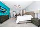 Spacious main bedroom with an accent wall, ample natural light, and a modern ceiling fan at 609 Big Pine Ave, Minneola, FL 34715